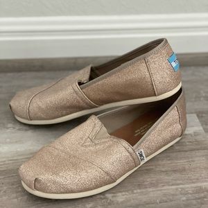 Gold glitter TOMS slip-on shoes